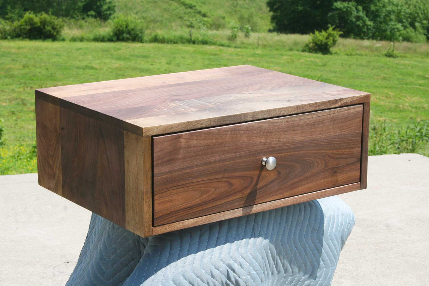 nightstand angled view walnut round handle
