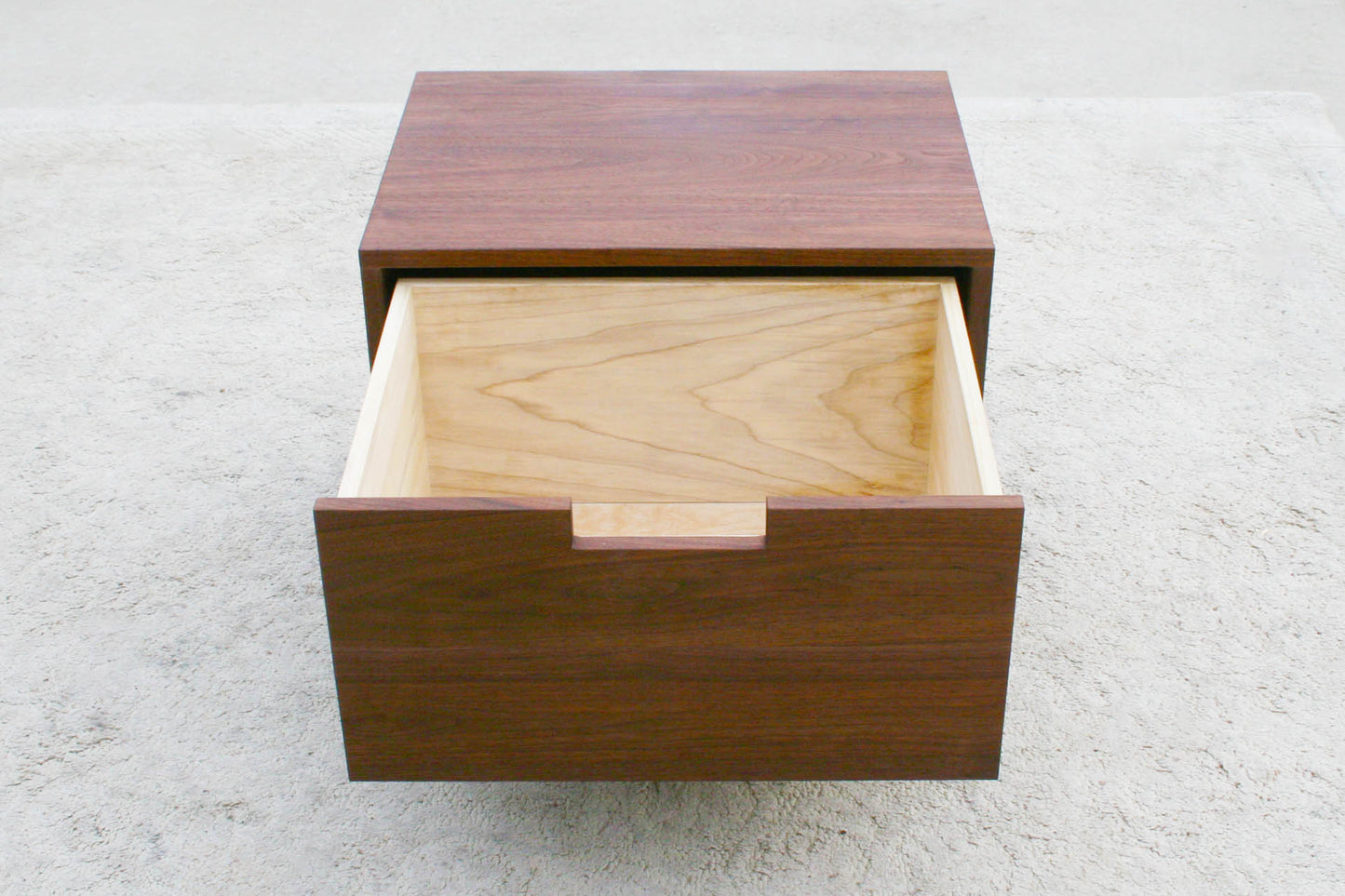 Low bedside table with one inset drawer open