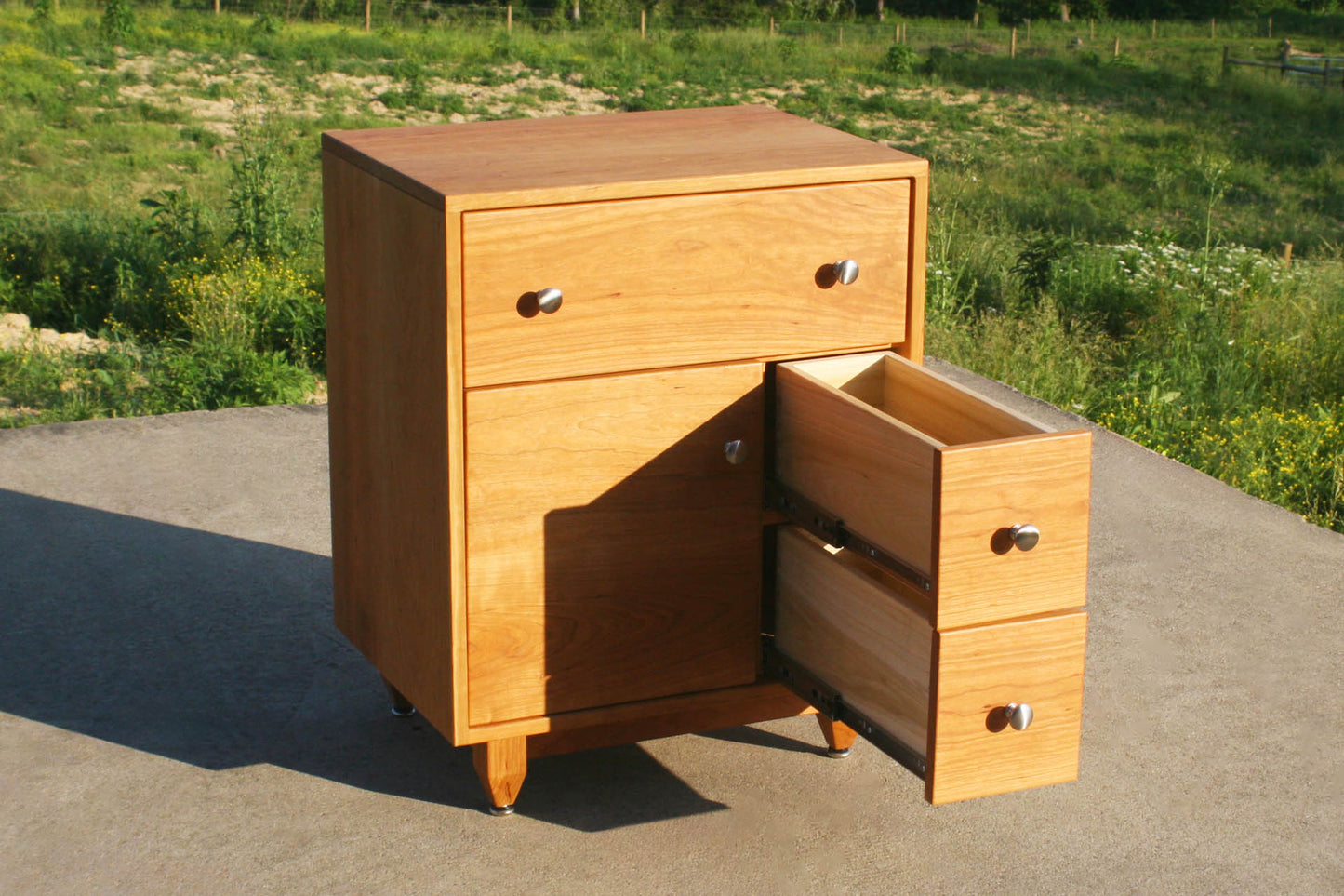 angled view Art Deco nightstand with small drawers open
