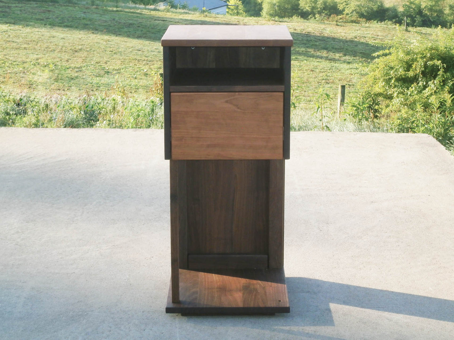 Overhanging table with drawer, shelf and support bar front view