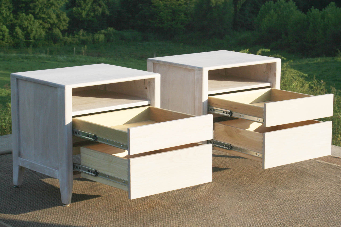 Bedside cabinet with raised framed sides angled view drawers open