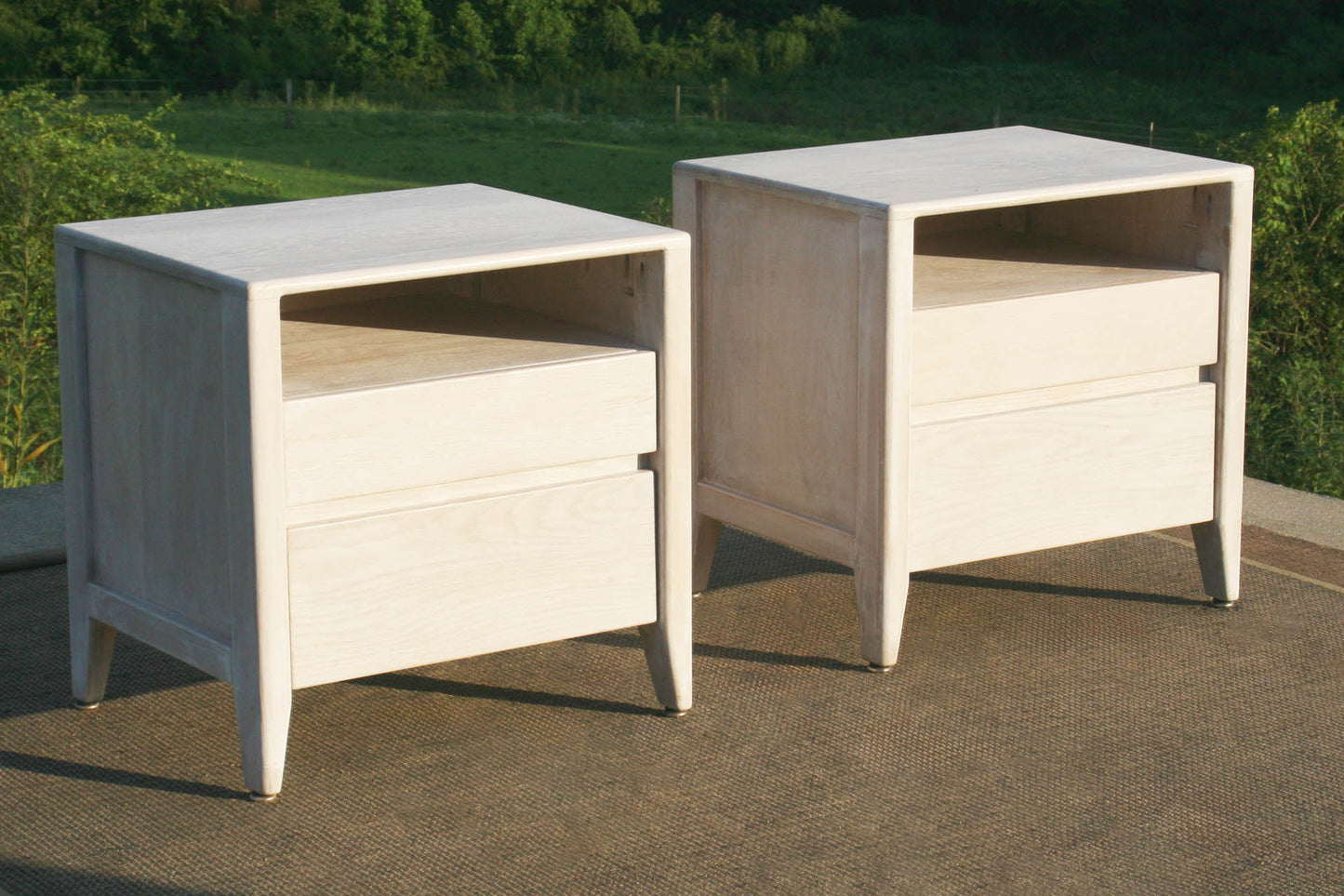 Bedside cabinet with raised framed sides angled view drawers closed