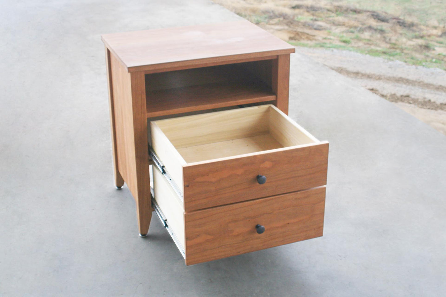 angled view Nightstand with 2 open drawers and 1 shelf