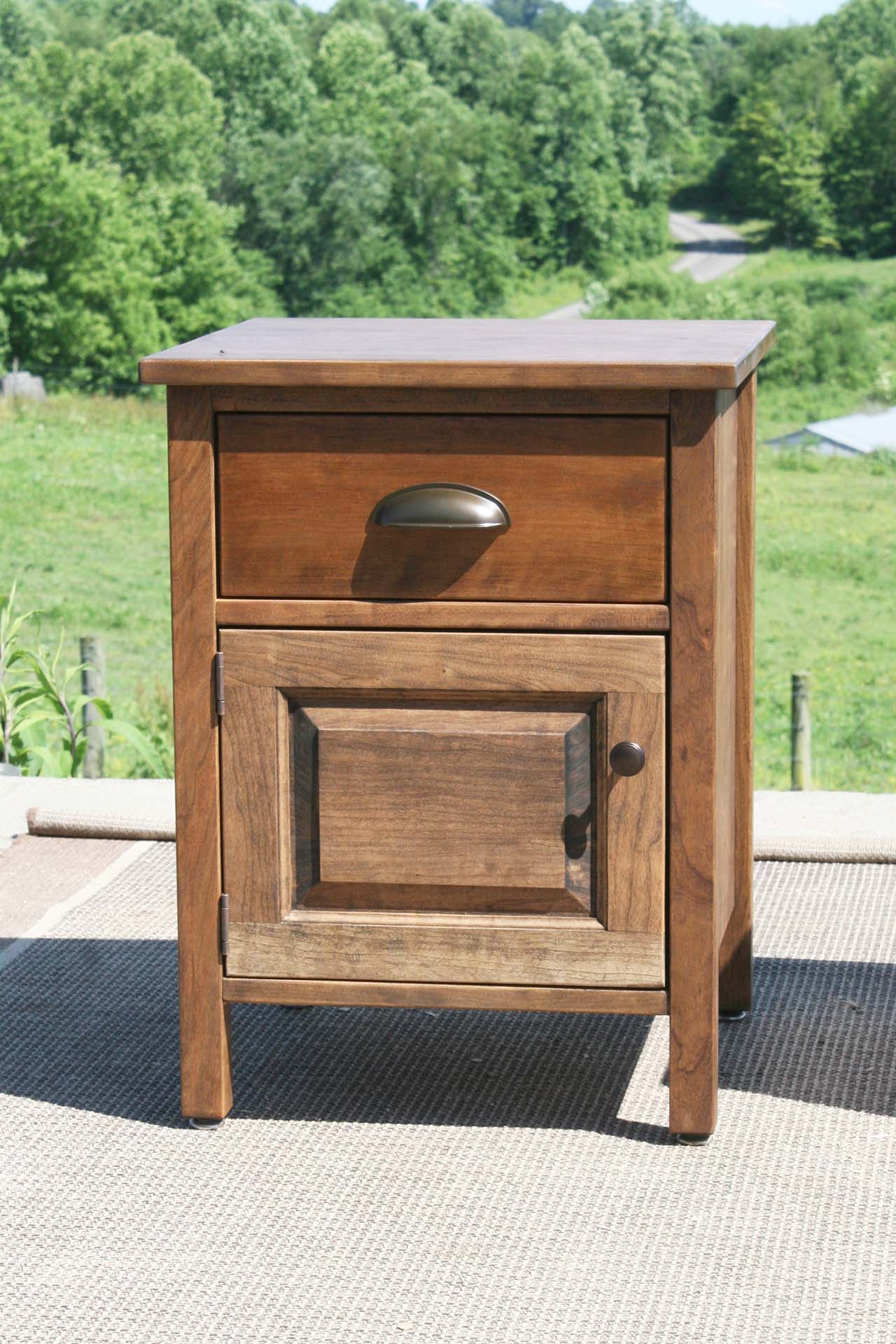 dark wood bedside cabinet with metal pull