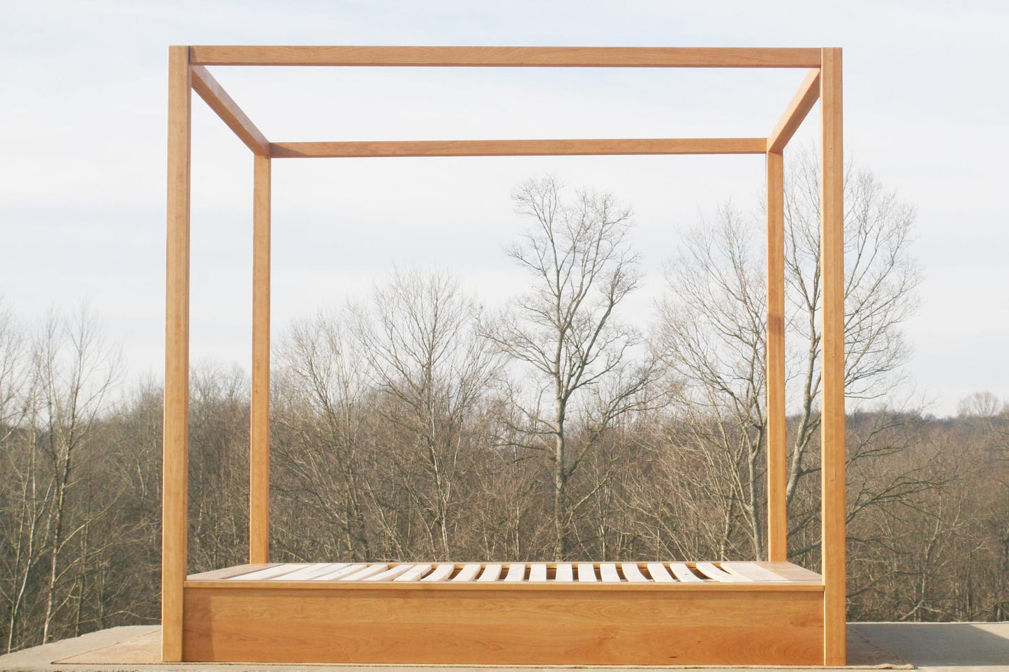 Modern canopy bed with wide platform and large rails side view