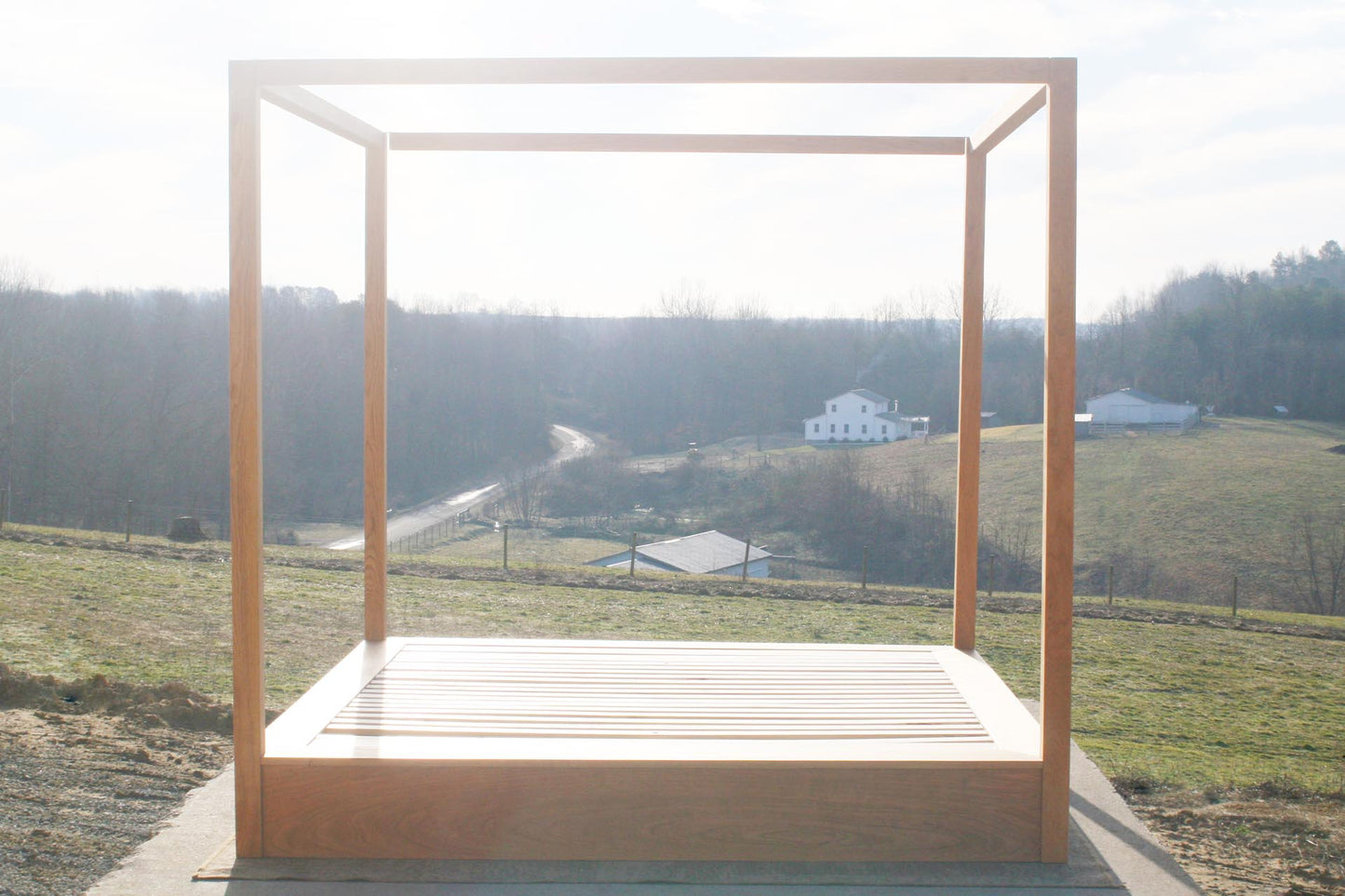 Modern canopy bed with wide platform and large rails front view