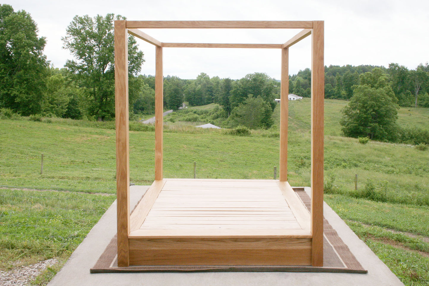 Low Platform Bed with large posts and canopy front view