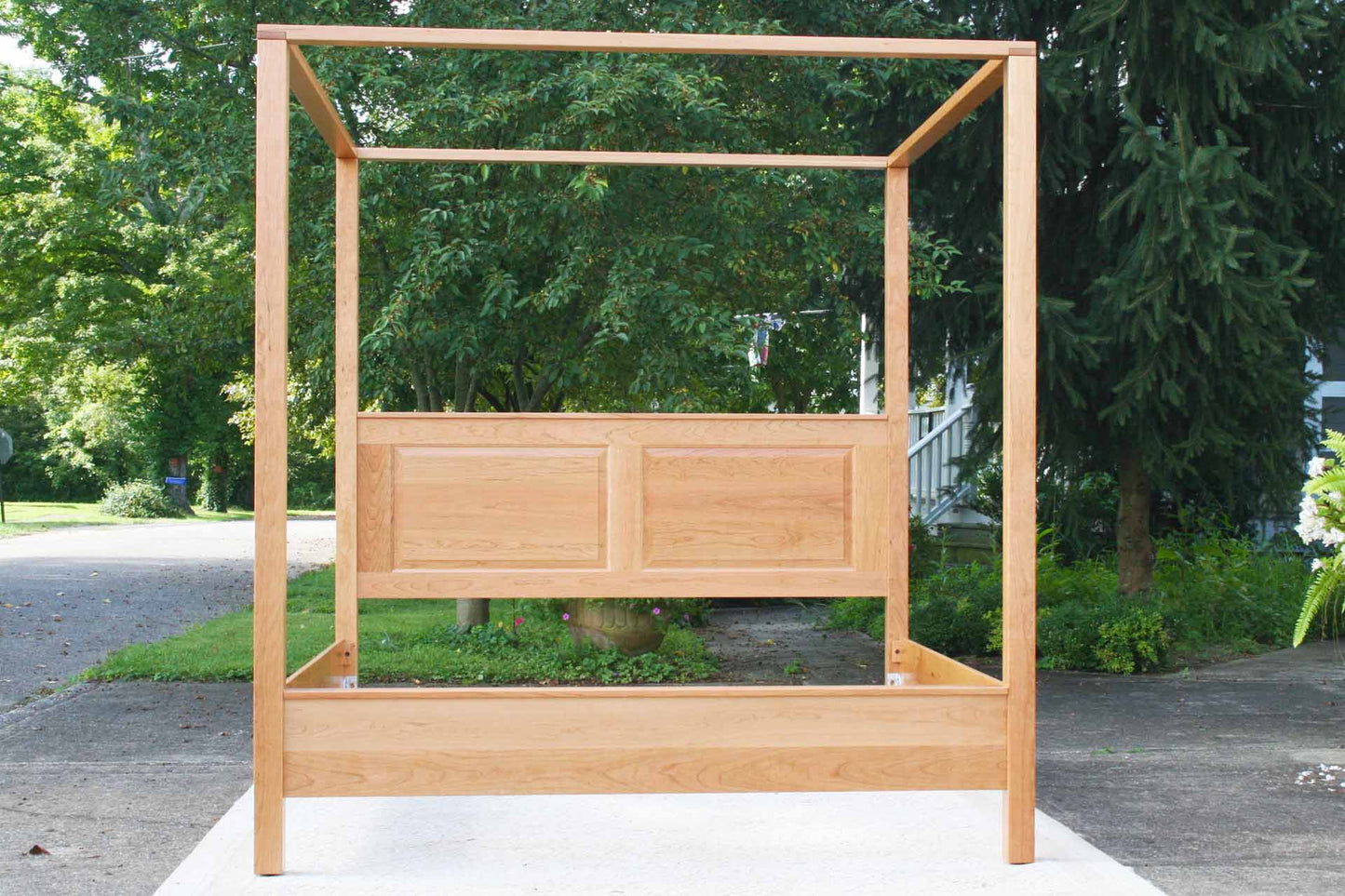 front view canopy bed with straight posts and paneled headboard natural
