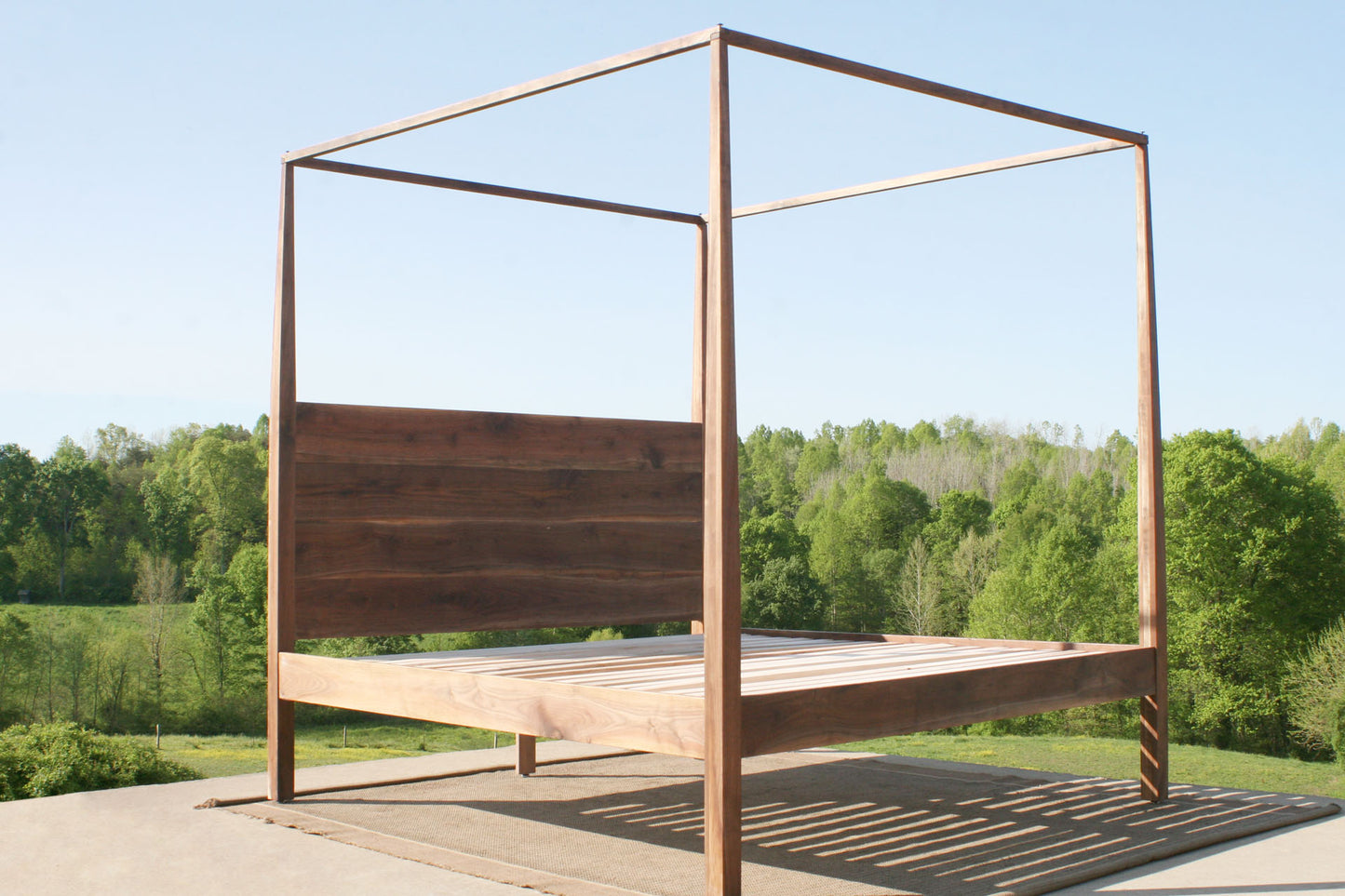 canopy bed with integrated headboard walnut angled view