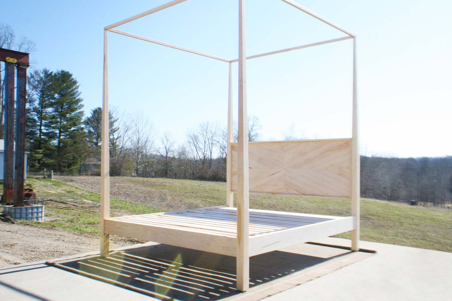 angled view natural Canopy bed with tapered posts and headboard