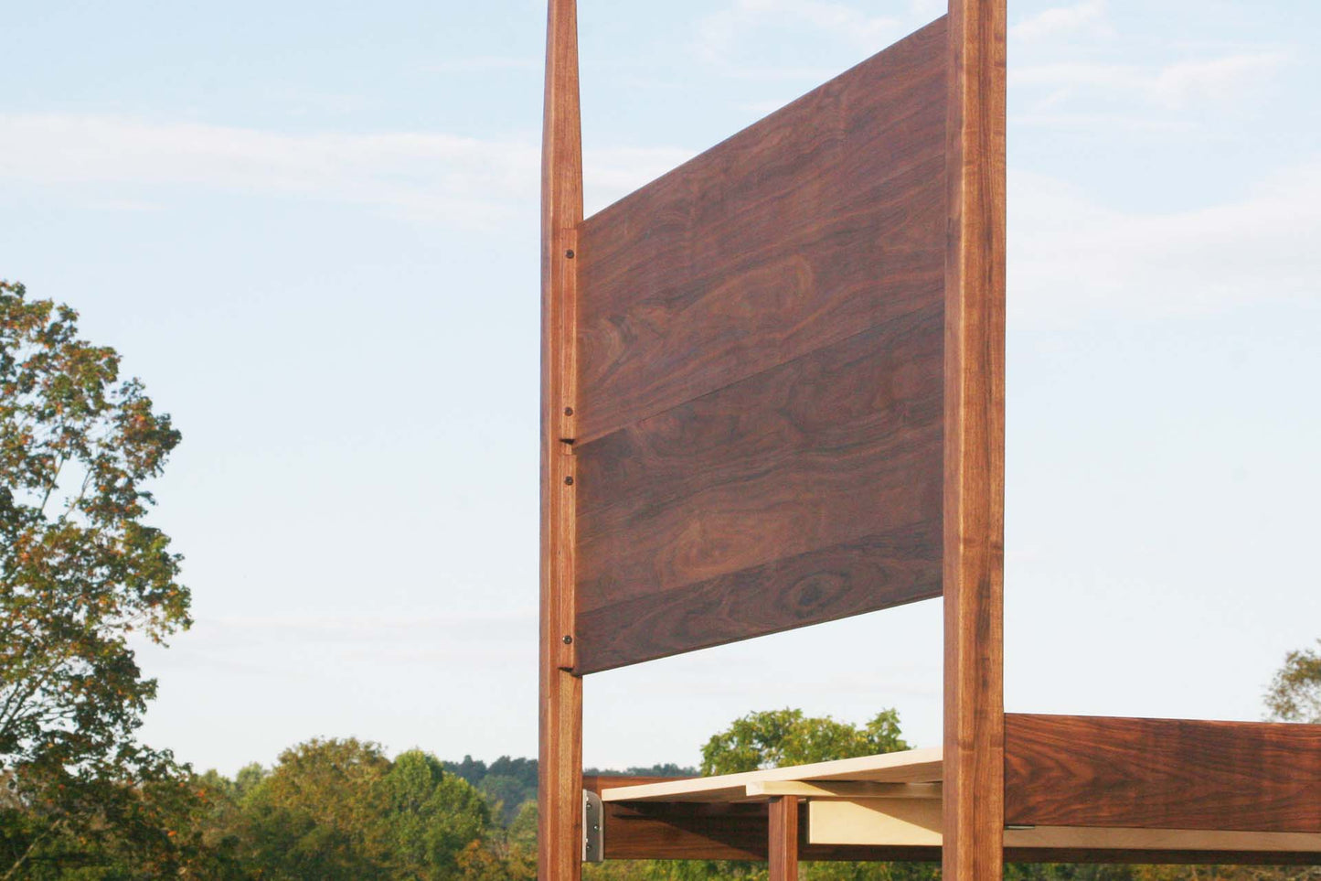 back of headboard of natural canopy bed with tapered posts