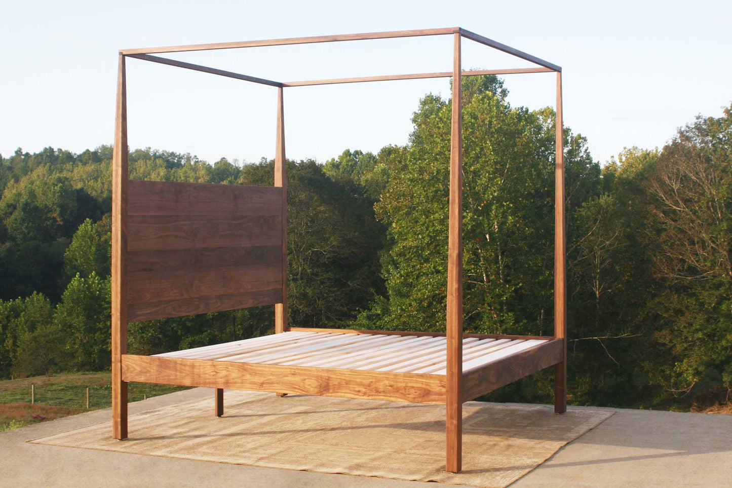 angled view natural canopy bed with tapered posts
