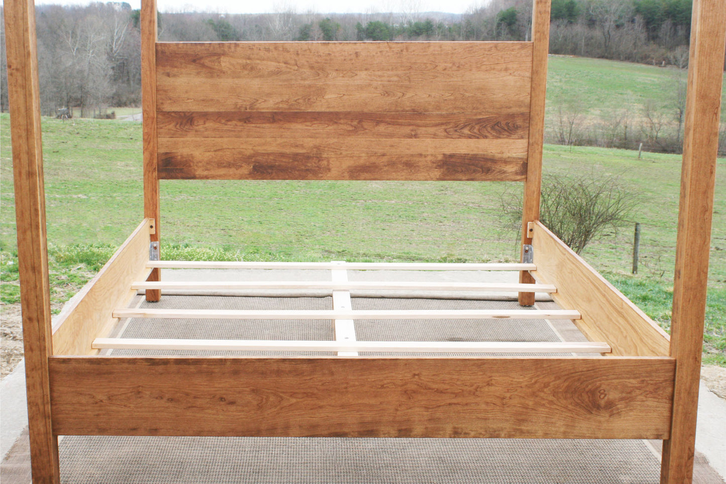 slats of natural Canopy Bed with a square headboard front view