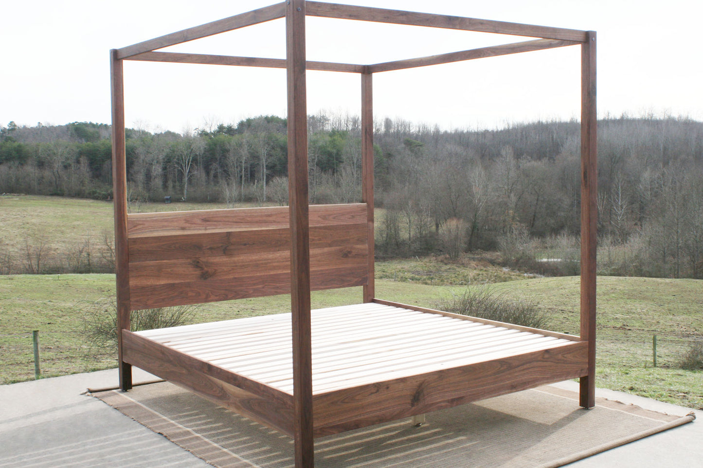 angled front view walnut canopy bed with square rails