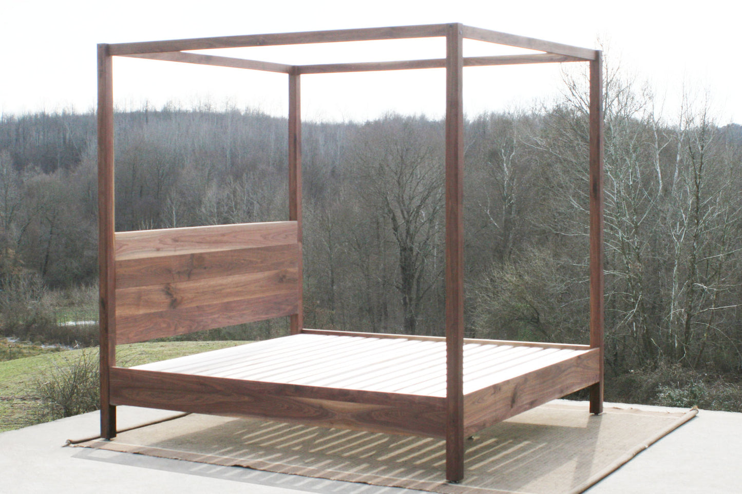 side angled view walnut canopy bed with square rails