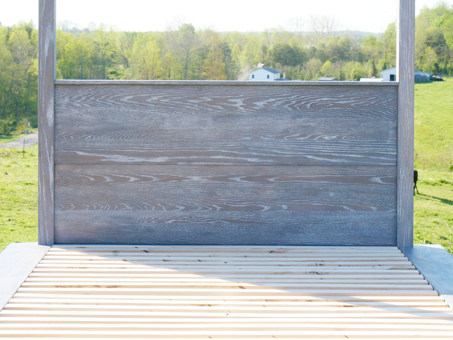 headboard of solid wood canopy bed with natural stain