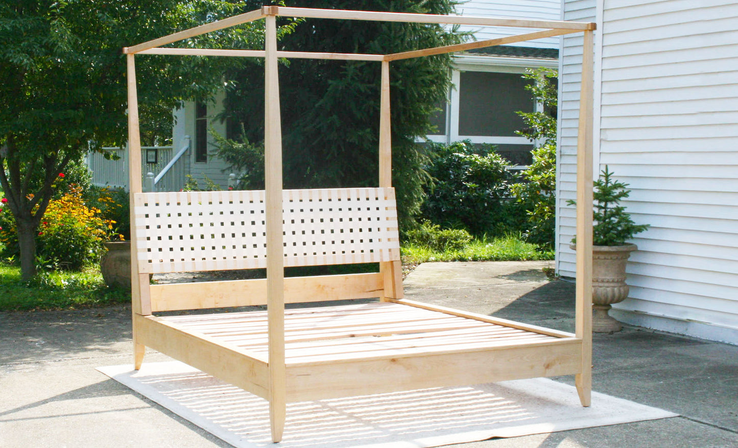 front view solid Canopy bed with woven headboard