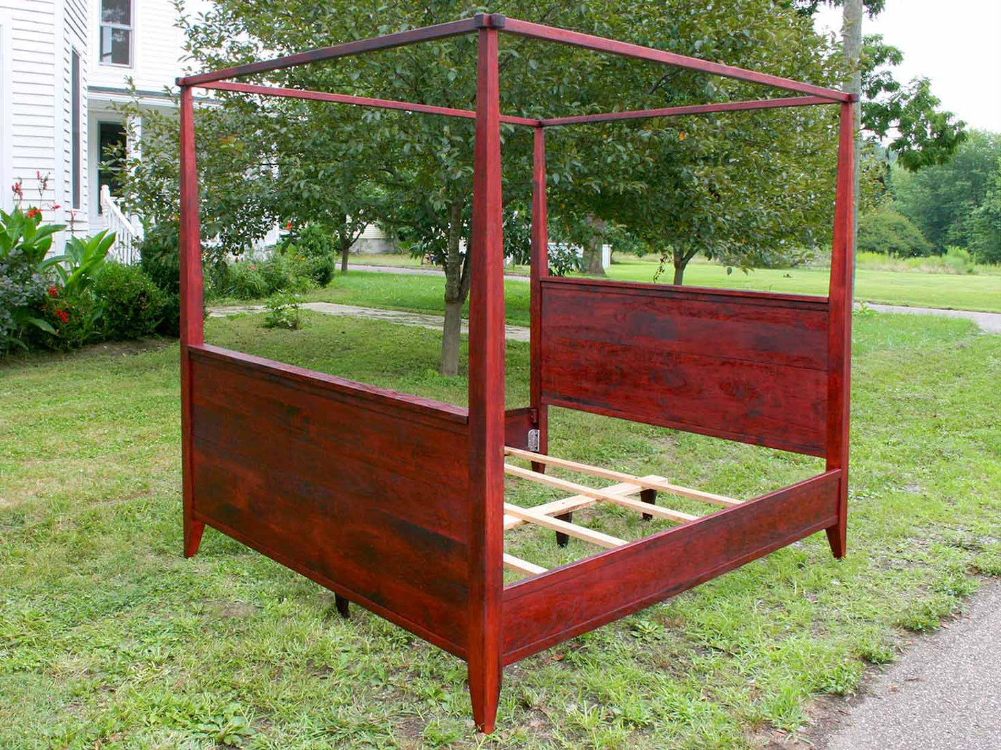 canopy bed with tall headboard and footboard angled view