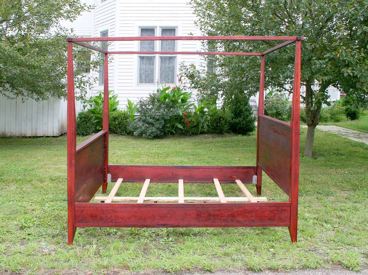 canopy bed with tall headboard and footboard side view