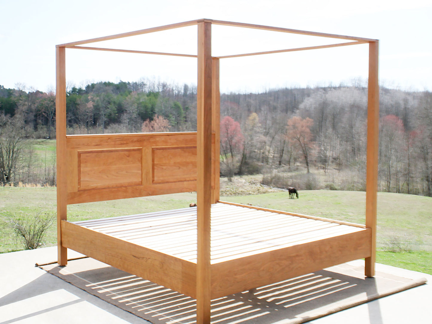 side angled view canopy bed with headboard