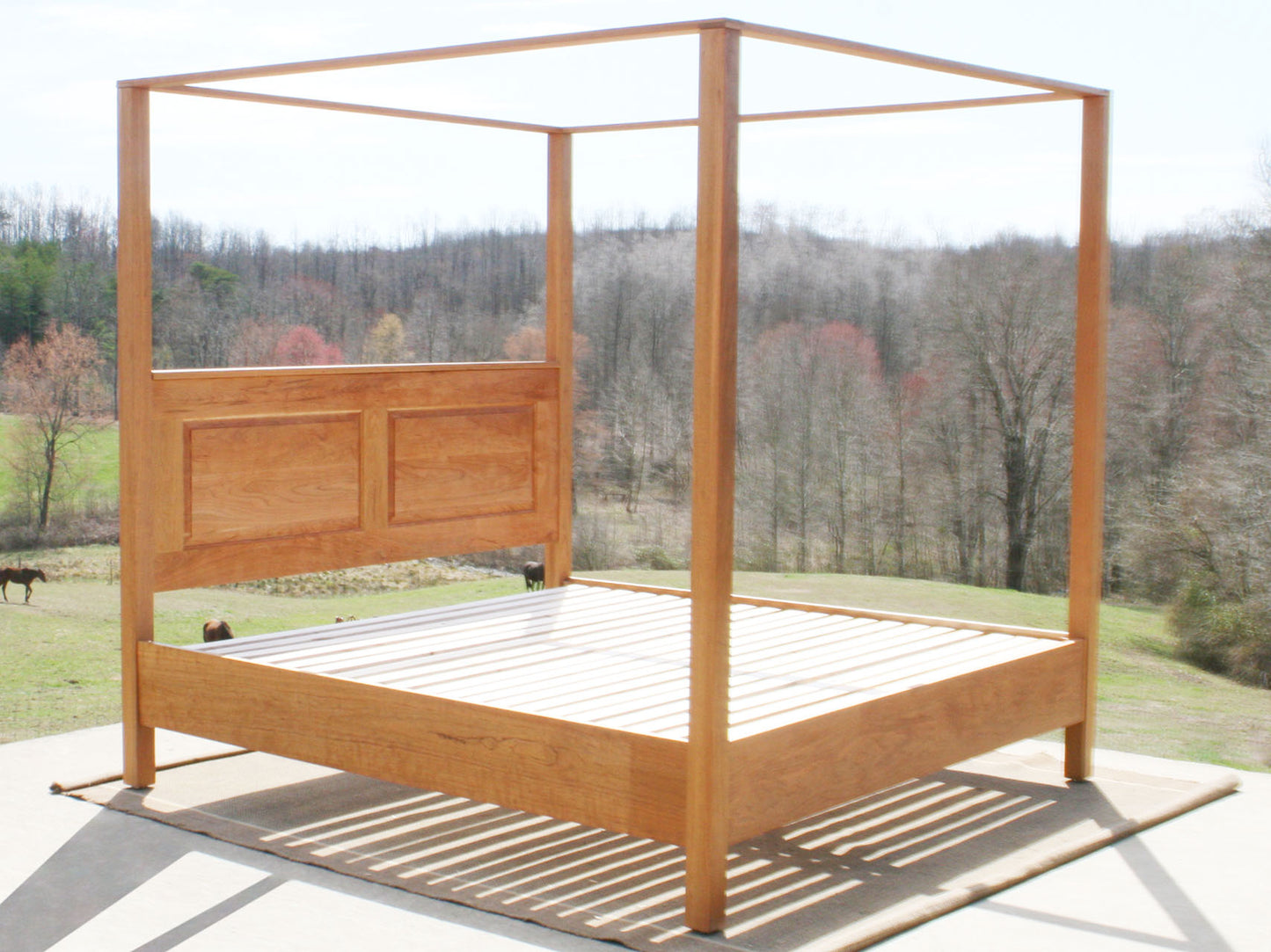 wood canopy bed with headboard side angled view