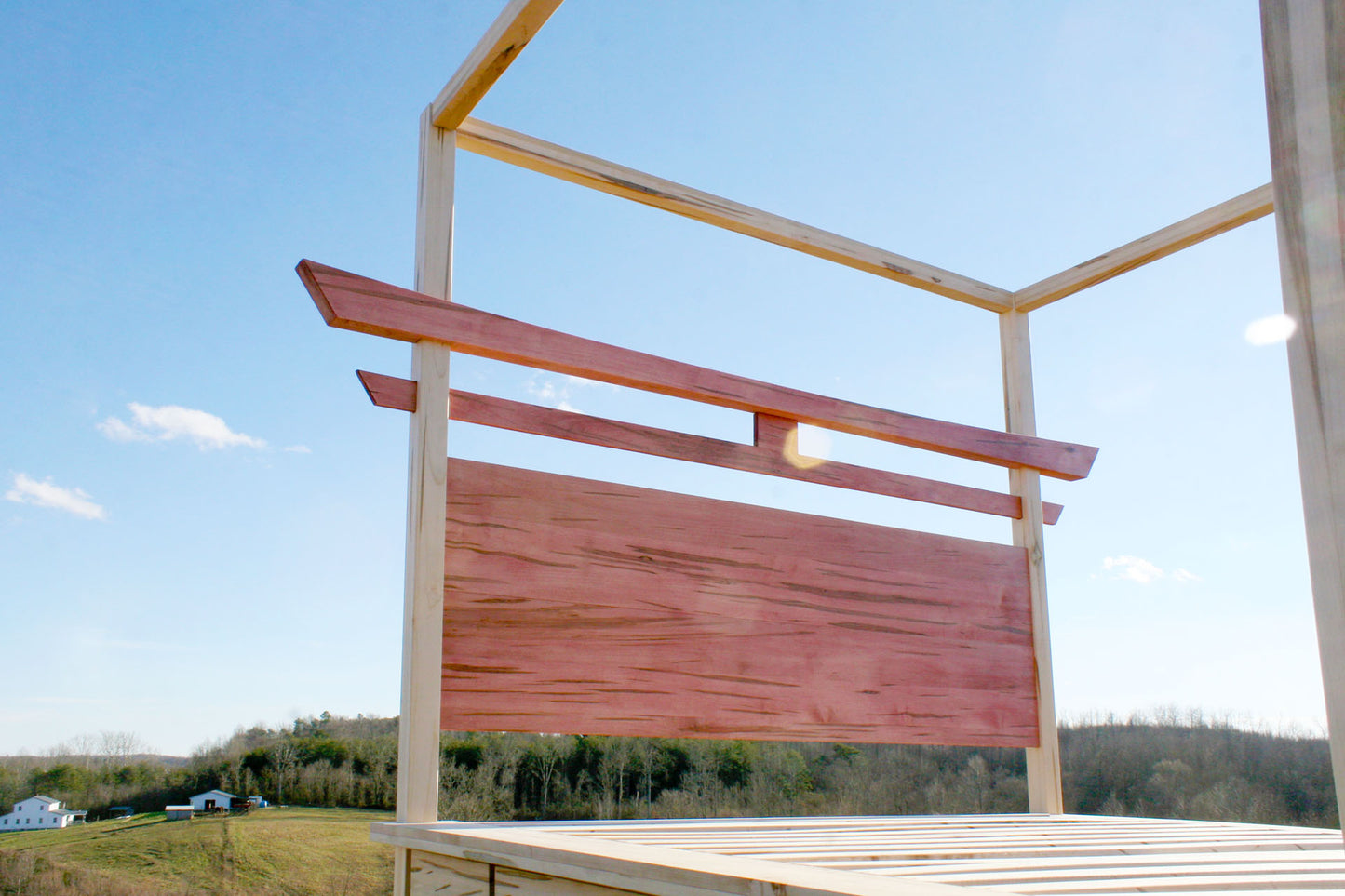 angled view of headboard of a Torii Gate bed with 6 drawers and square canopy