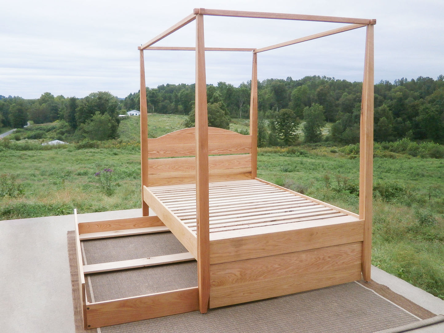 wood Canopy bed with trundle and arched headboard and trundle bed open
