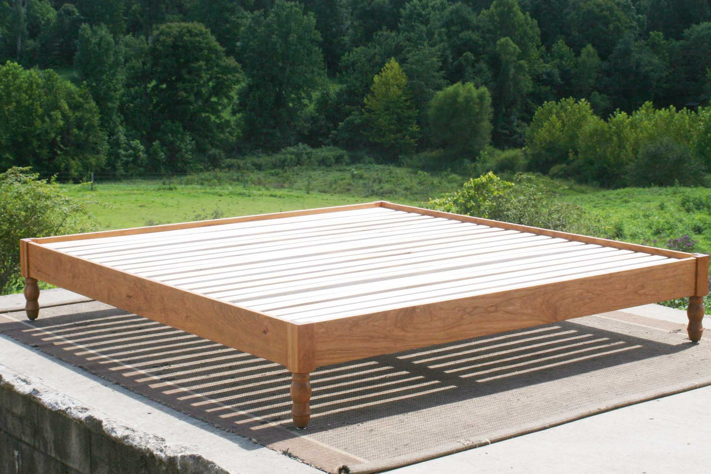 platform bed with turned corner posts angled view
