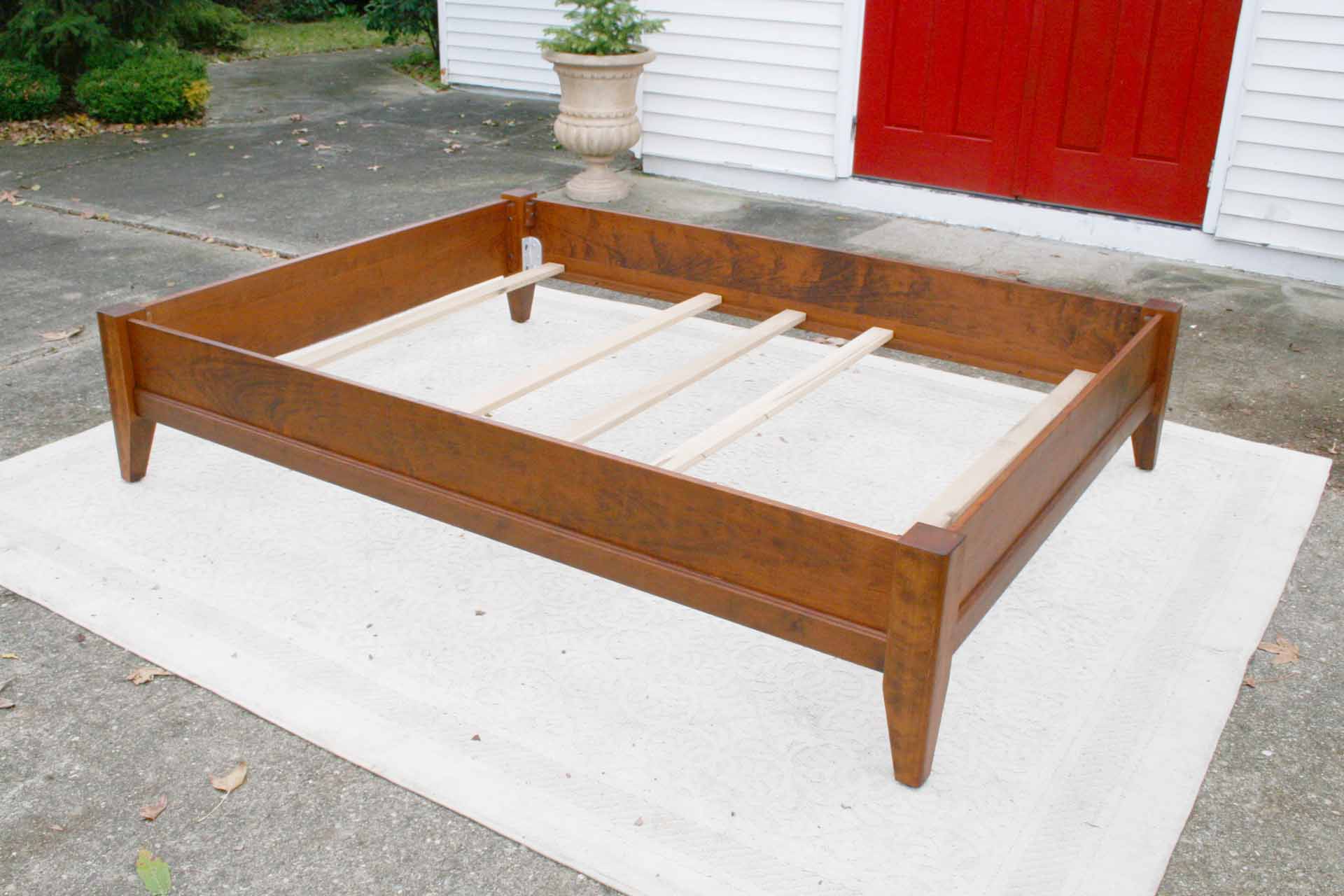 solid wood bed with trim top angled view