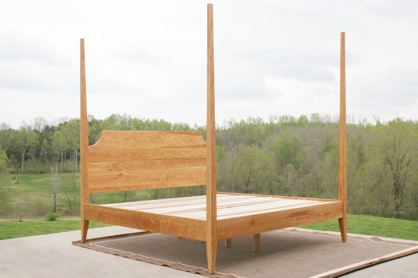 angled view natural Four poster bed with tapered posts