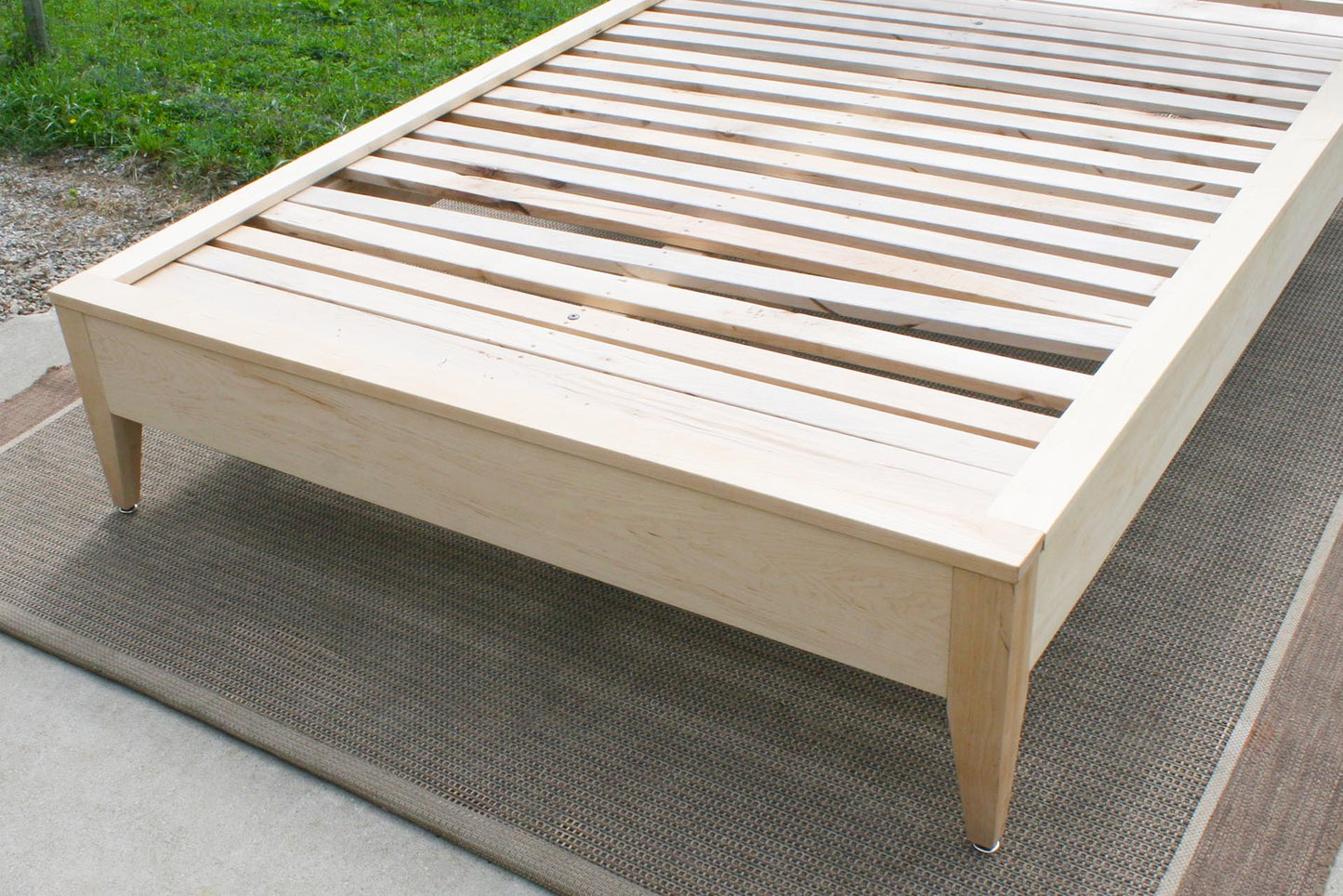 slats of Platform bed with organic fabric headboard in solid hardwood