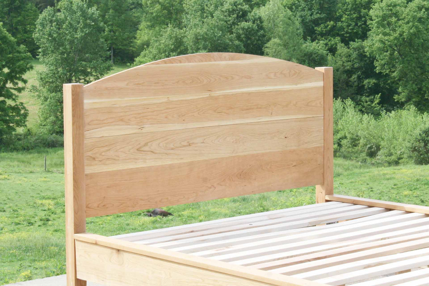 white oak platform bed with curved headboard