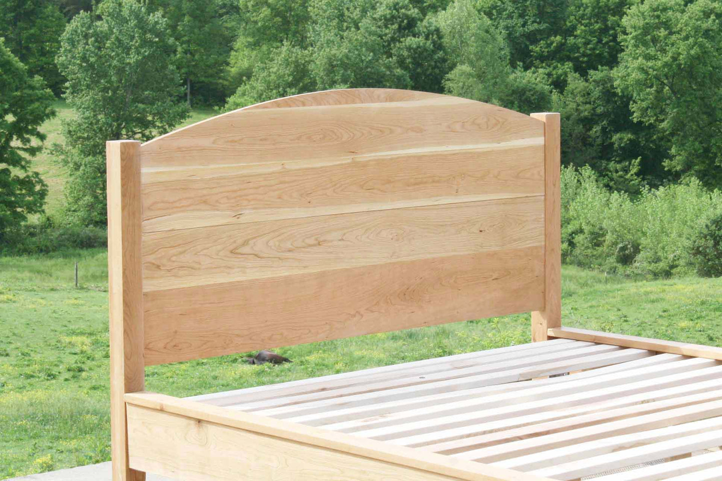 white oak platform bed with curved headboard
