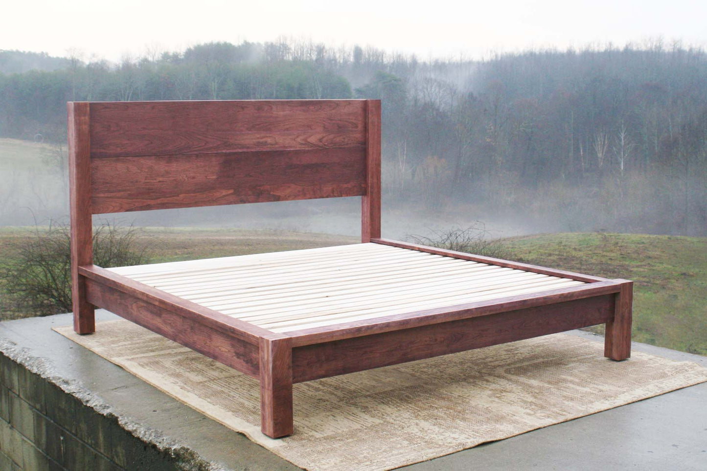 angled view platform bed with thick posts and vertical headboard