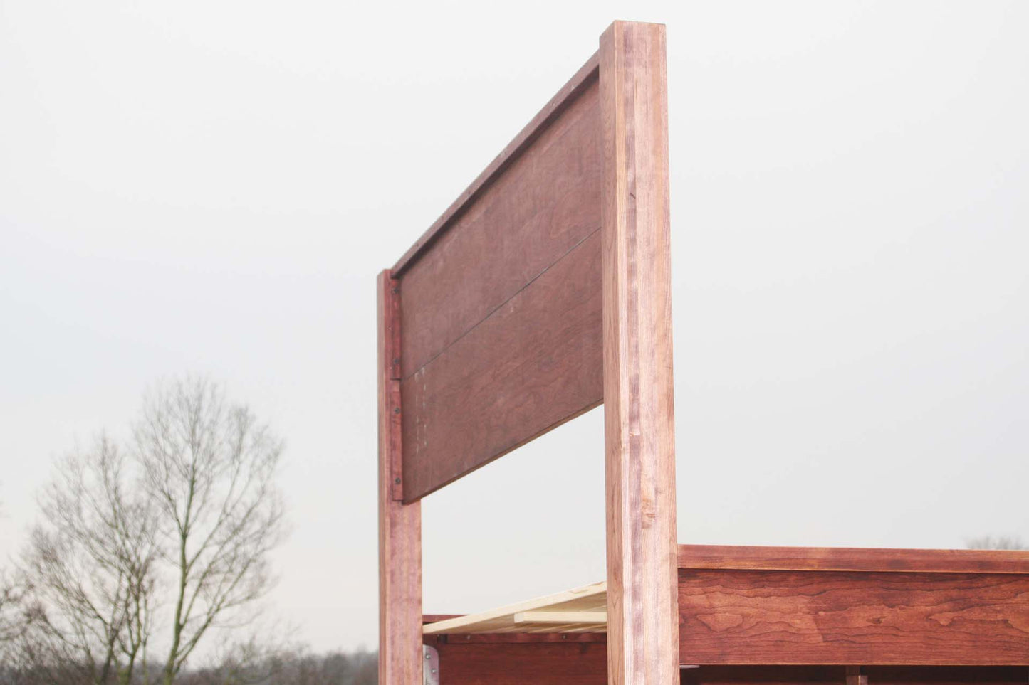 back of platform bed with thick posts and vertical headboard
