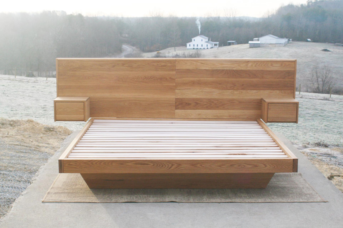 Floating platform bed with headboard and attached nightstands front view