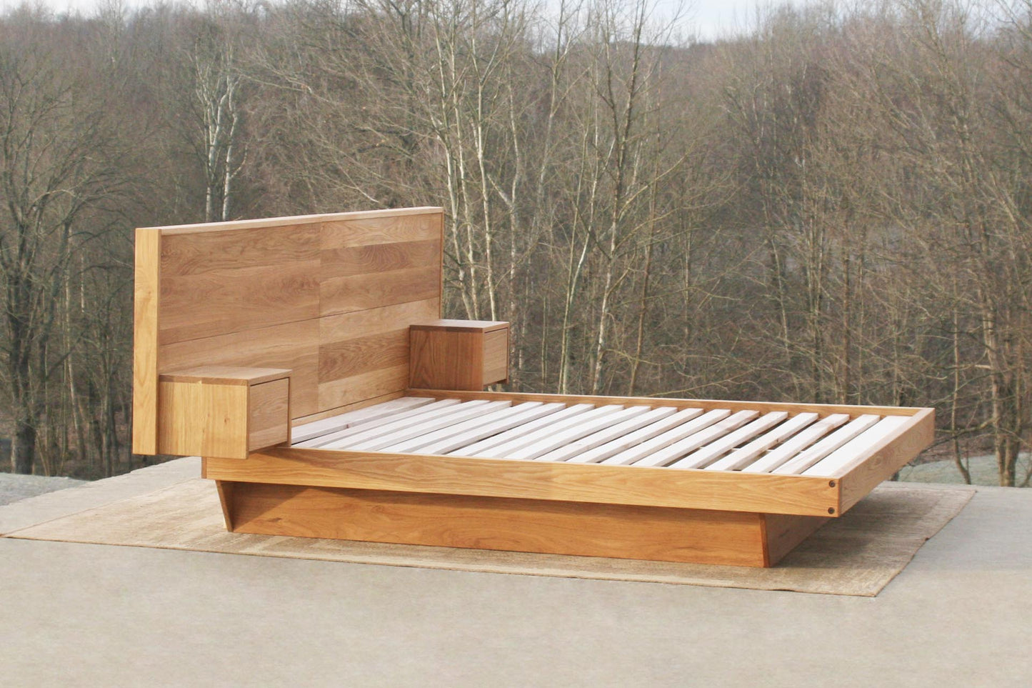 angled view Floating platform bed with headboard and attached nightstands