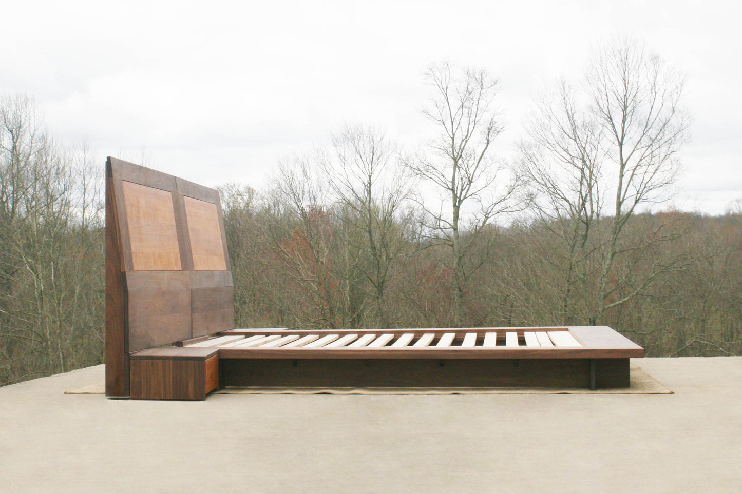 Low platform bed with side tables side view