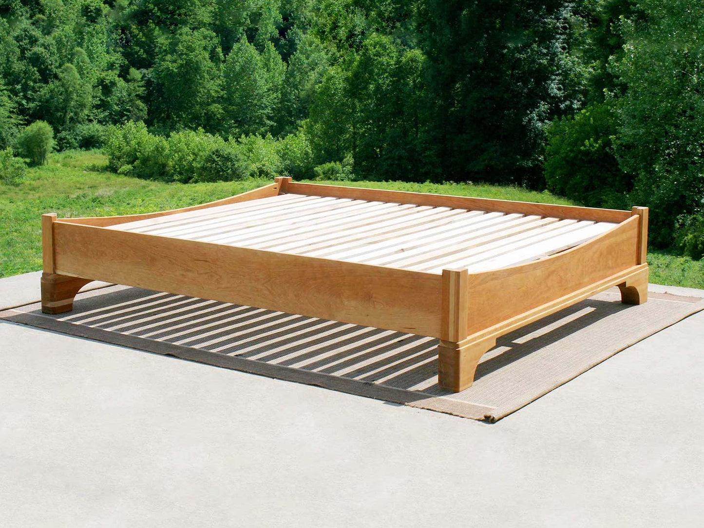 Platform Bed with large block feet and arched ends side view natural