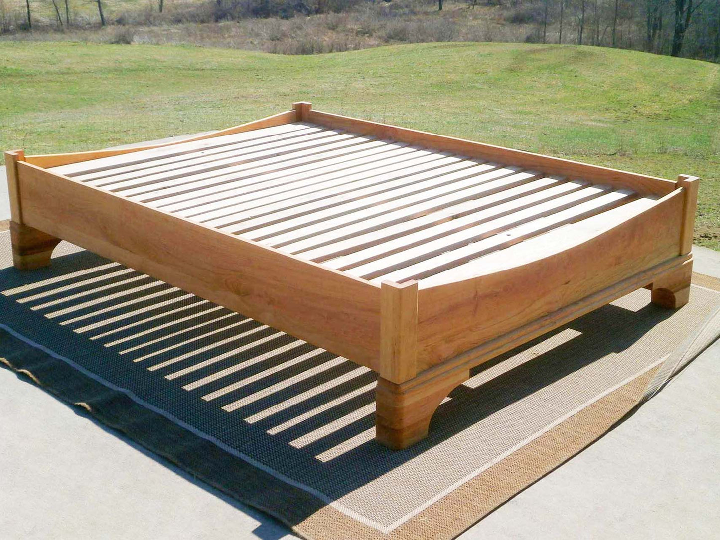 top angled view Platform Bed with large block feet and arched ends