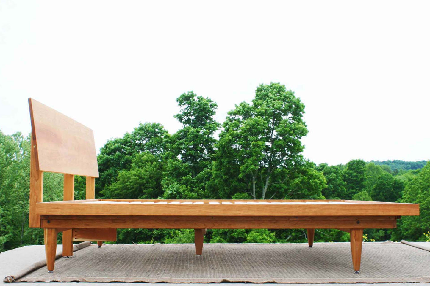 side view angled headboard bed natural wood