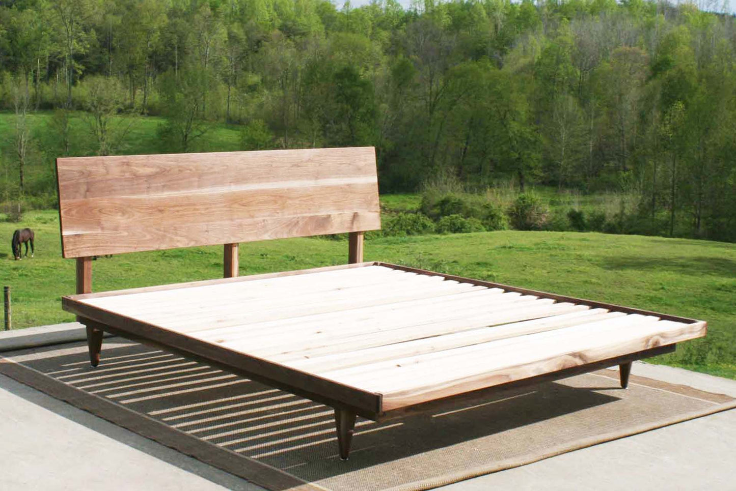 angled view walnut mid century platform bed
