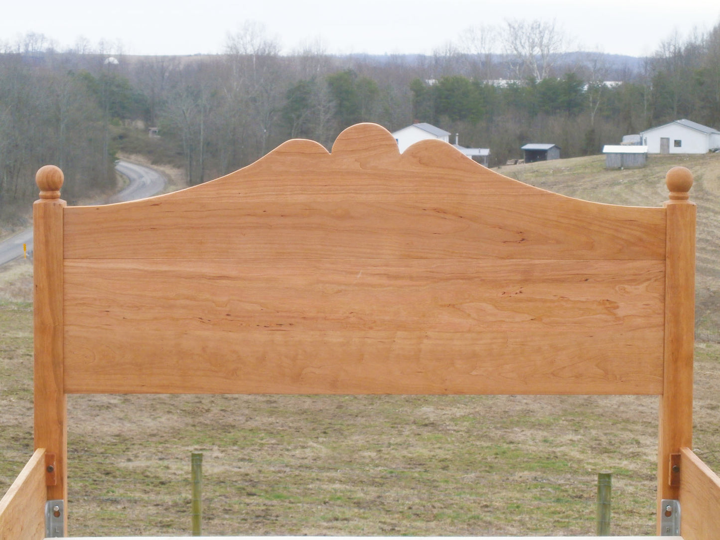 headboard of Classic four poster bed with turned posts and scrolled headboard