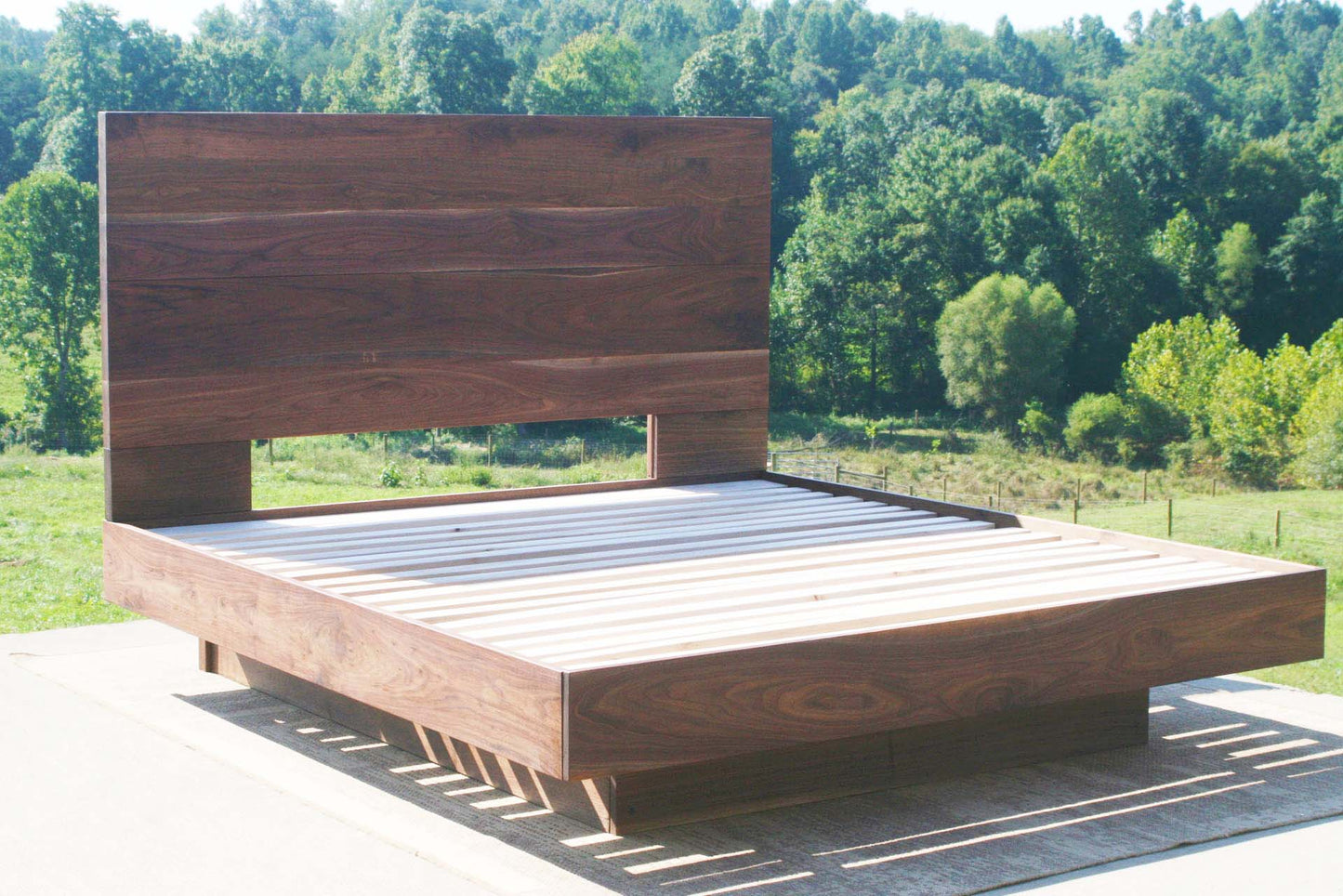 floating walnut platform bed angled view