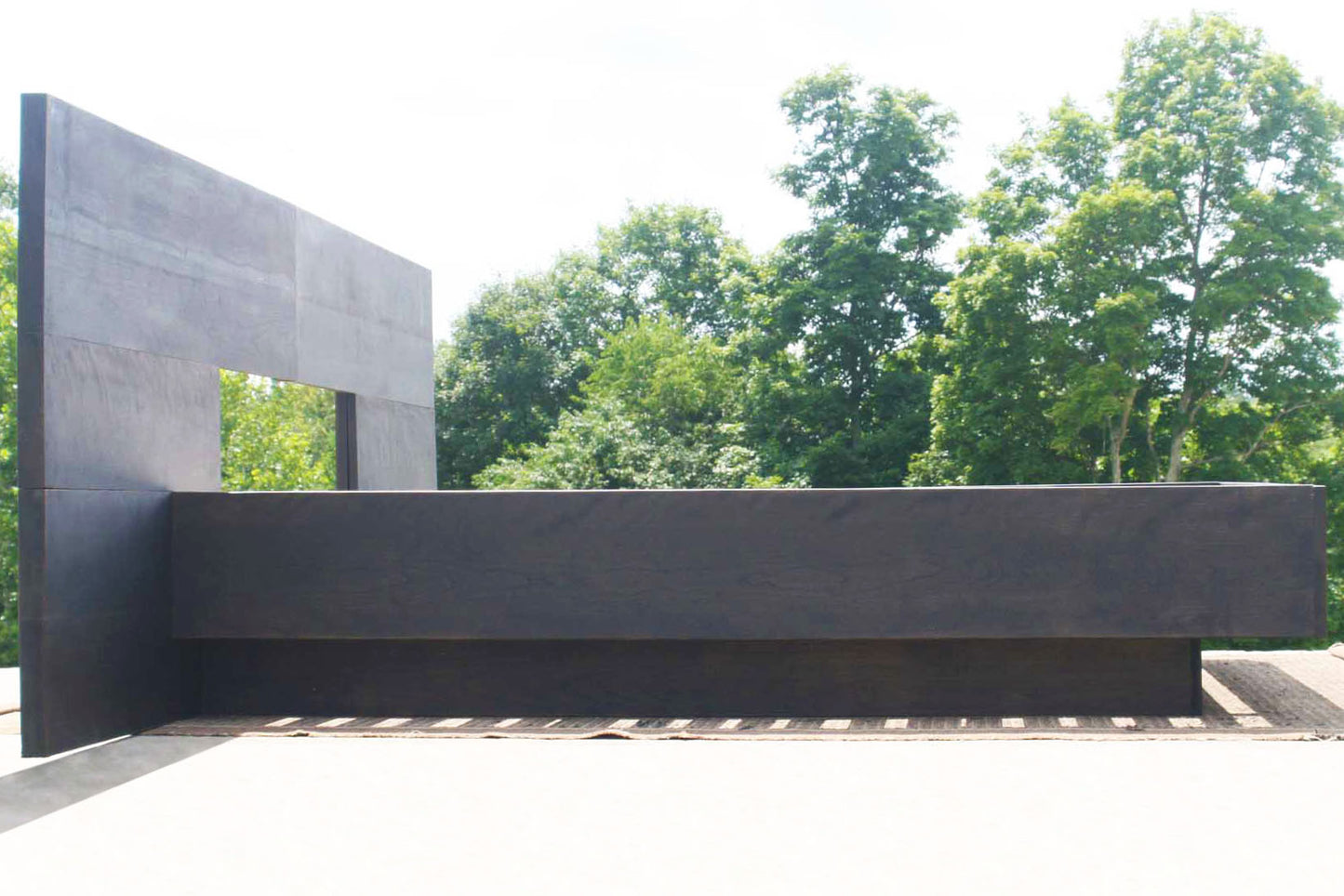 hardwood cantilever bed with large headboard side view