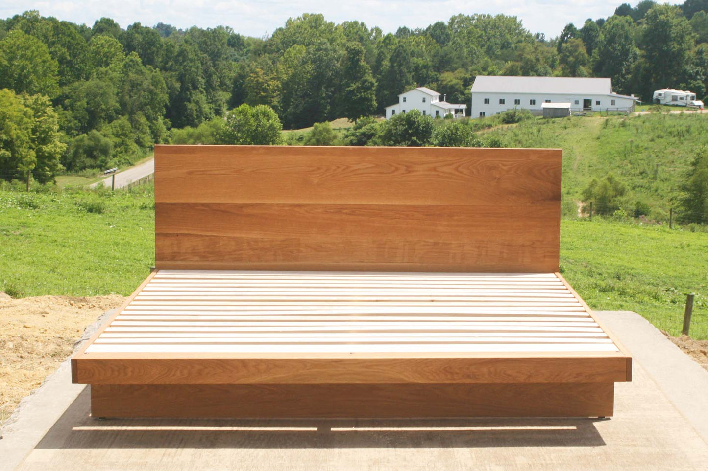 natural cantilever platform bed with headboard front view