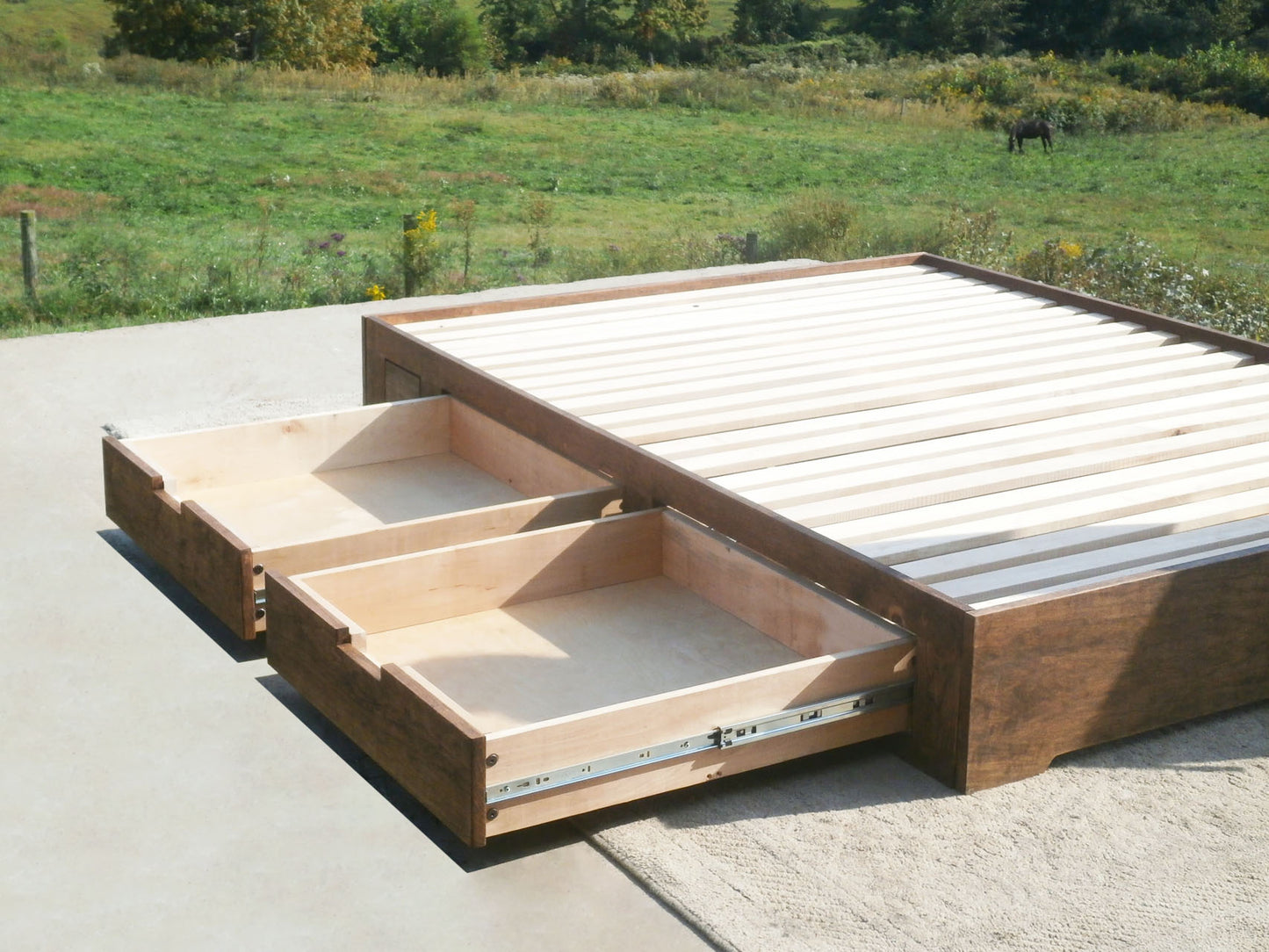 angled view Low profile storage bed with 4 drawers two drawers open
