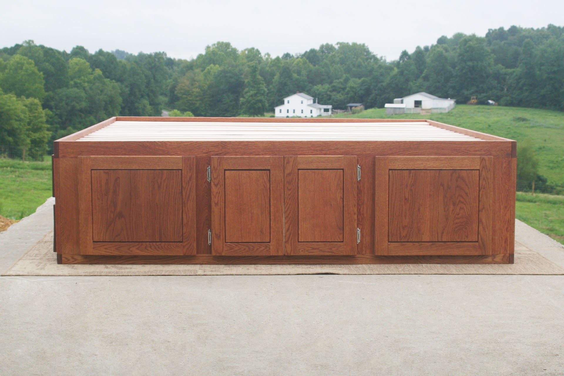 front view natural hardwood Platform bed with 12 drawers and center storage area