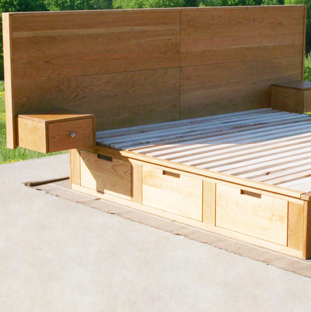 low angled view of 6 drawer storage bed with built-in nightstands