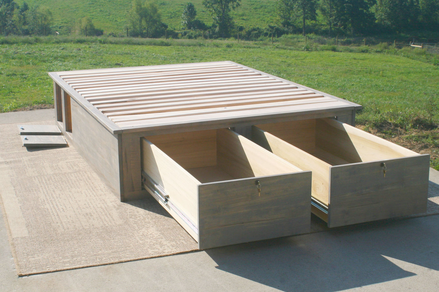 platform bed with front drawers open 3 quarter view